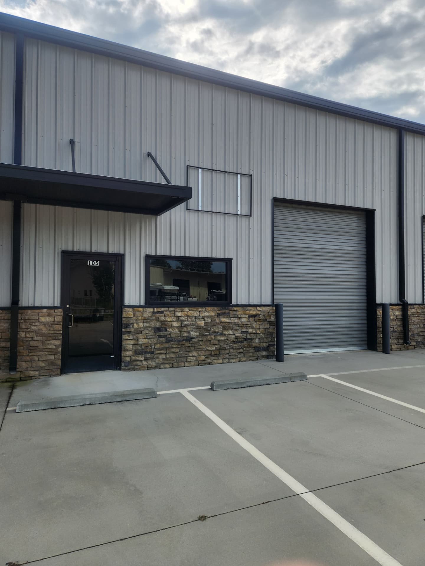 Capital Priority warehouse suite exterior with glass entry, showroom window and roll-up bay door